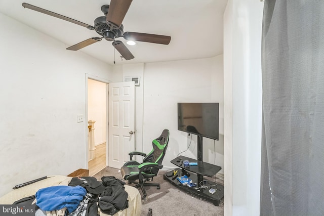 workout area featuring light carpet and ceiling fan