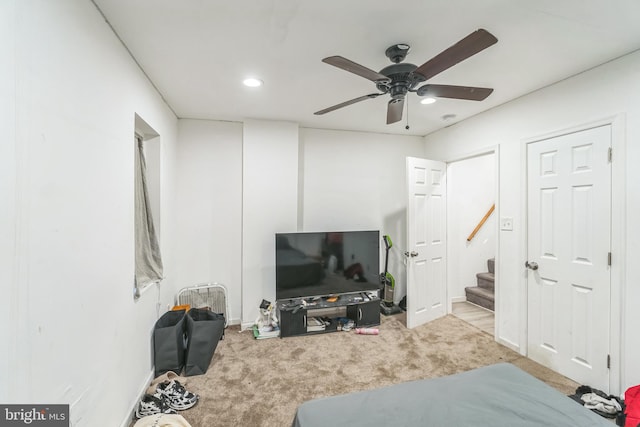 bedroom with light carpet and ceiling fan