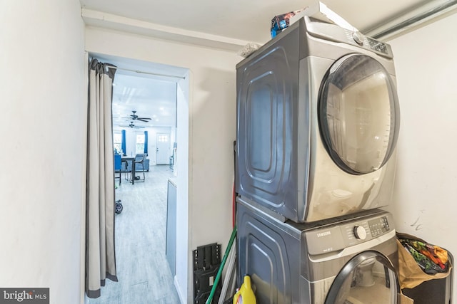 laundry area with hardwood / wood-style flooring, stacked washer and dryer, and ceiling fan