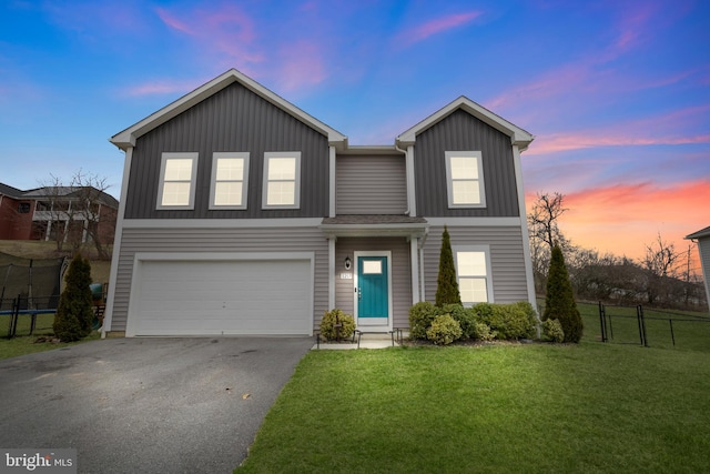 view of front of property featuring a lawn and a garage