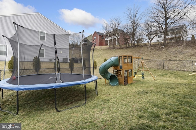 view of yard featuring a trampoline and a playground