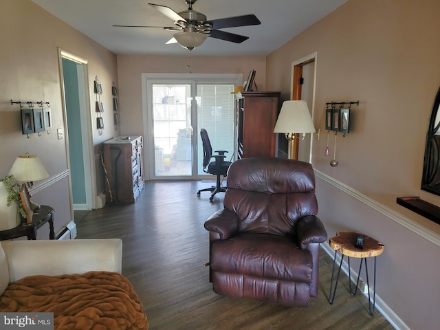 living room with dark hardwood / wood-style flooring and ceiling fan