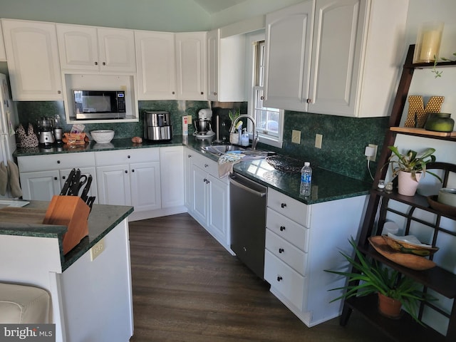 kitchen featuring sink, white cabinets, dark wood-type flooring, and appliances with stainless steel finishes