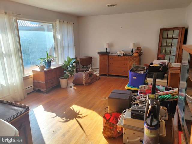 interior space with hardwood / wood-style flooring and a baseboard radiator