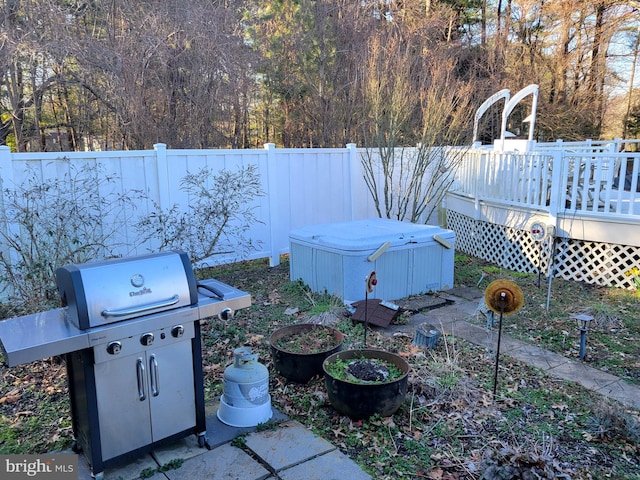 view of yard with a hot tub and a deck