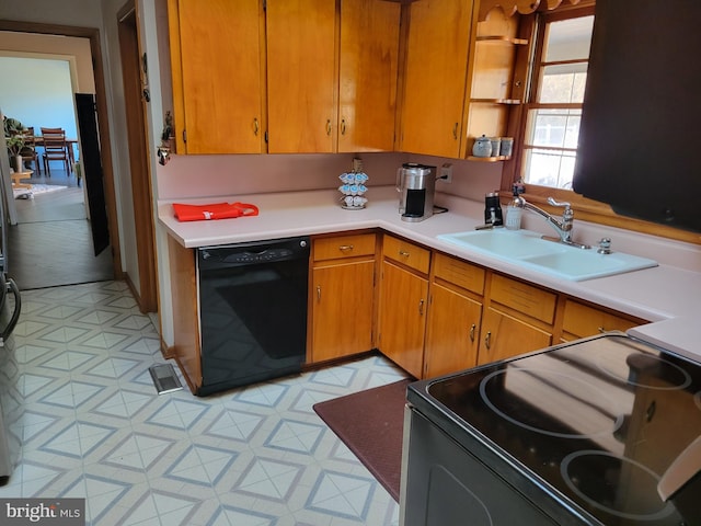 kitchen with sink, dishwasher, range, and light tile floors