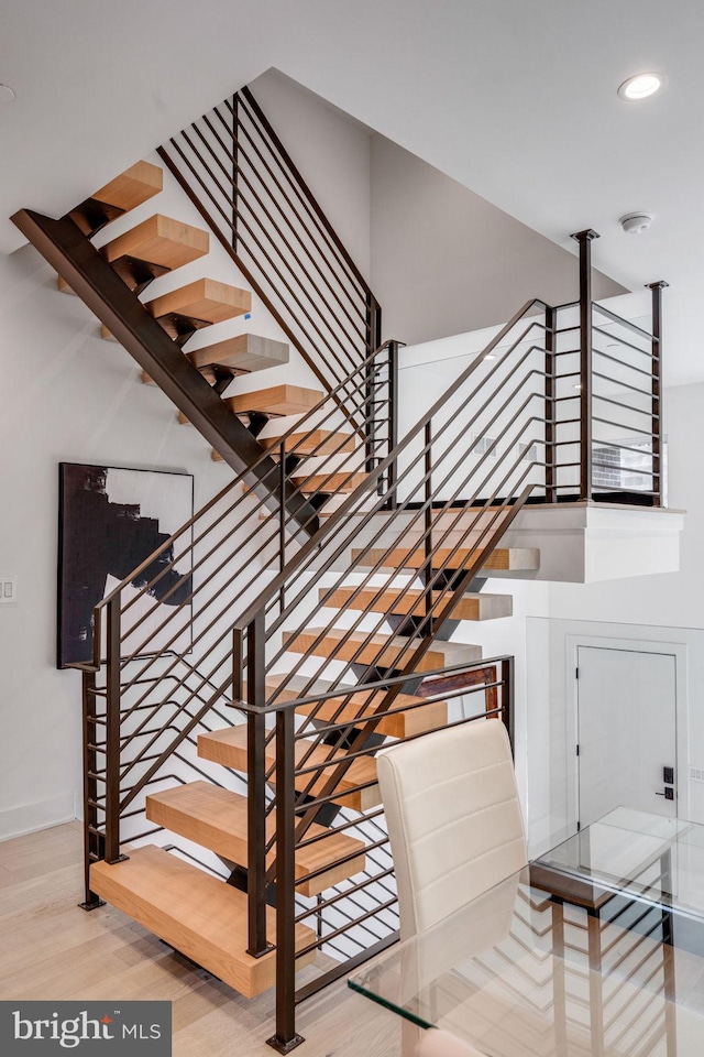 stairway featuring light hardwood / wood-style flooring