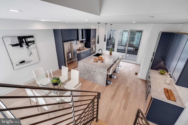 living room with sink and light hardwood / wood-style floors