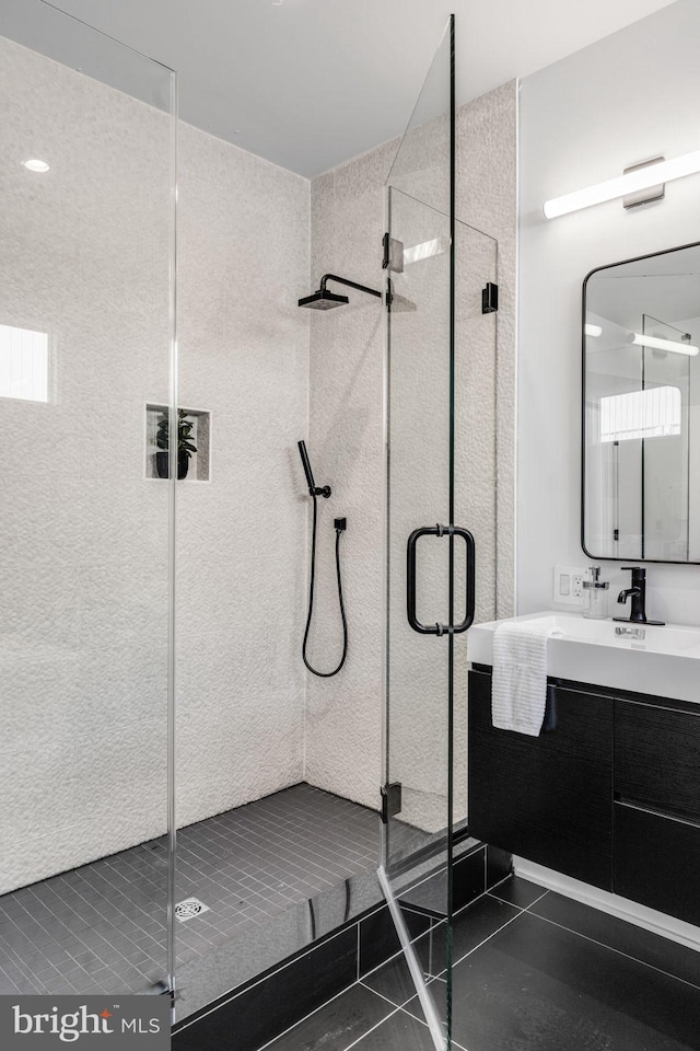 bathroom with large vanity, tile floors, and an enclosed shower