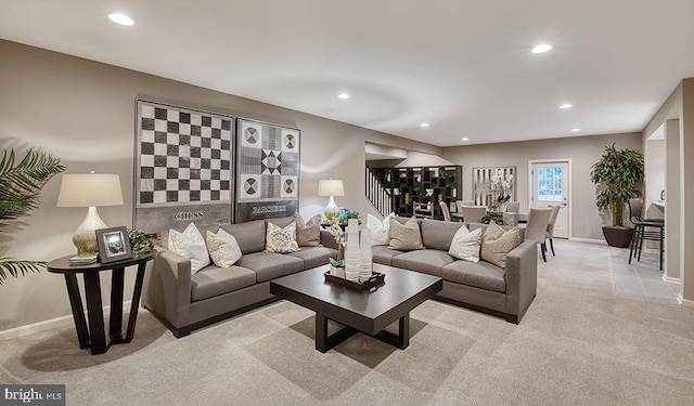 living room with light carpet, stairs, baseboards, and recessed lighting