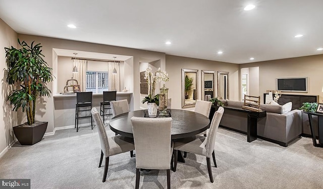 dining area featuring recessed lighting, light carpet, and baseboards