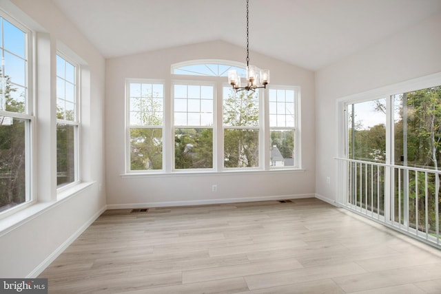 unfurnished sunroom with lofted ceiling and a chandelier