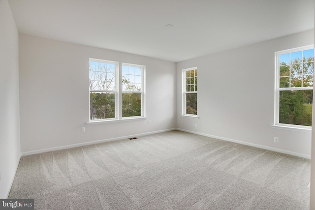 carpeted spare room with baseboards