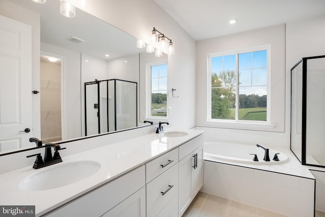 bathroom featuring double vanity, a sink, and a shower stall