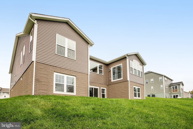 rear view of property with a lawn