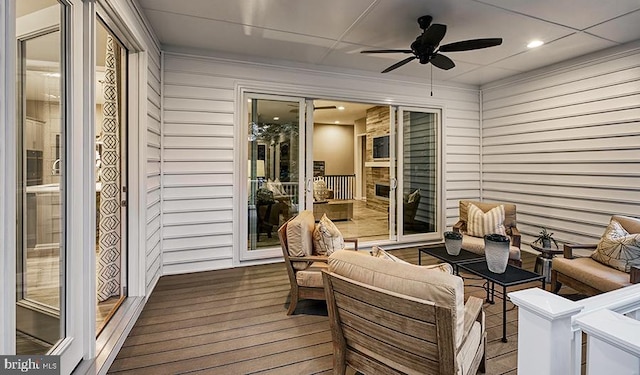 deck featuring ceiling fan and outdoor lounge area