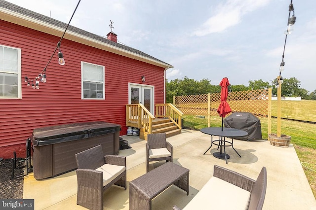 view of terrace featuring grilling area and a hot tub