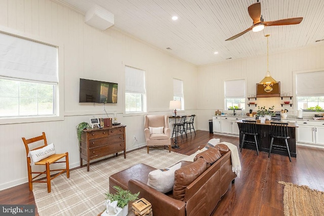 living room with ceiling fan, plenty of natural light, and hardwood / wood-style flooring