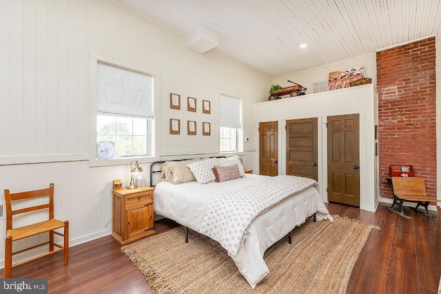 bedroom with dark hardwood / wood-style flooring