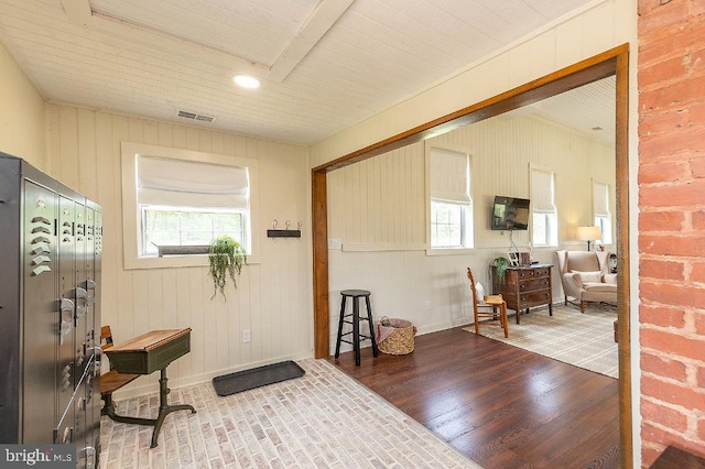 foyer entrance featuring wood-type flooring and a healthy amount of sunlight