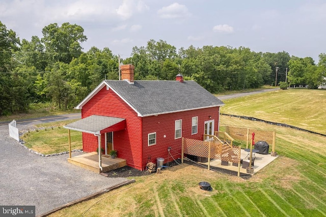 exterior space featuring a lawn and a deck