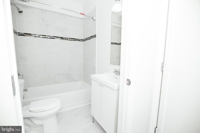 full bathroom with vanity, tiled shower / bath combo, and toilet