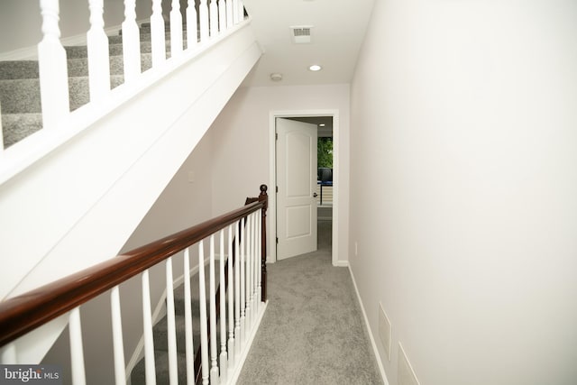 hall featuring light colored carpet