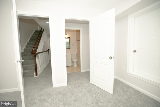 interior space with a healthy amount of sunlight and light carpet