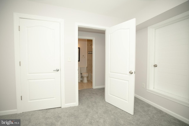 unfurnished bedroom featuring light carpet