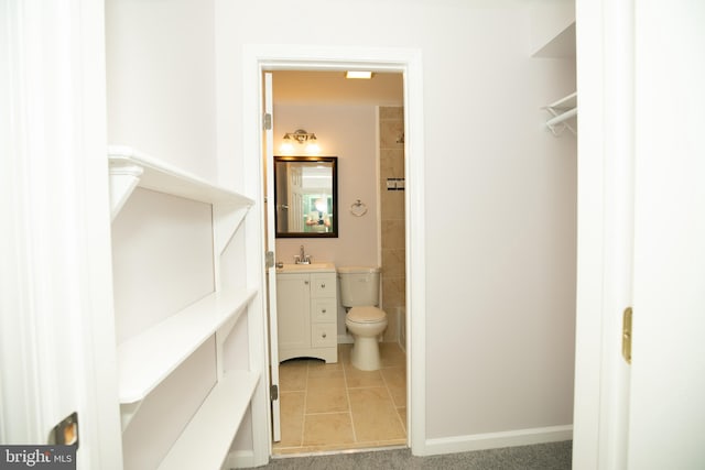 bathroom with vanity, tile patterned floors, and toilet