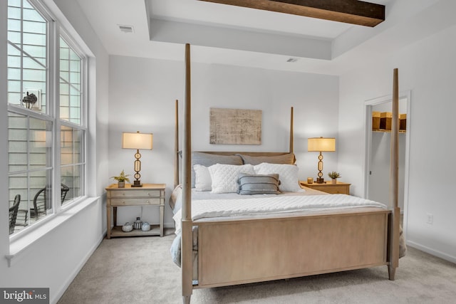 carpeted bedroom featuring beamed ceiling