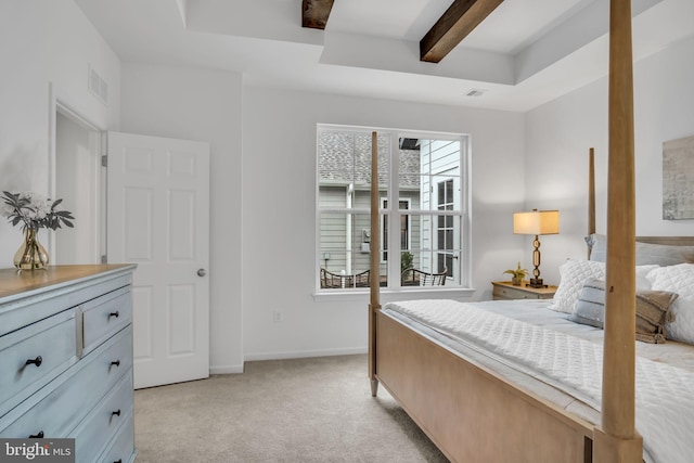 bedroom with beam ceiling and light colored carpet