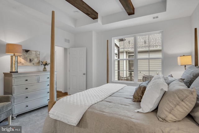 carpeted bedroom with beamed ceiling