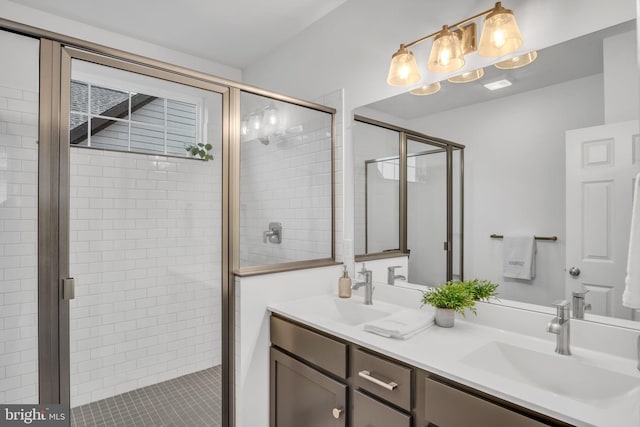 bathroom with vanity and a shower with door