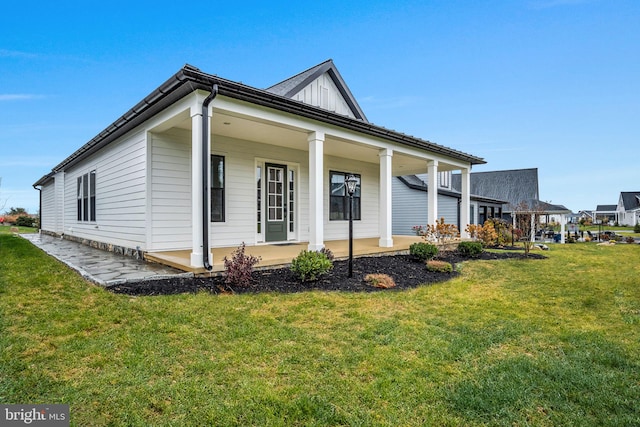 view of side of property with a yard and a porch