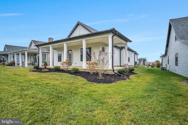 view of home's exterior with a porch, central air condition unit, and a lawn