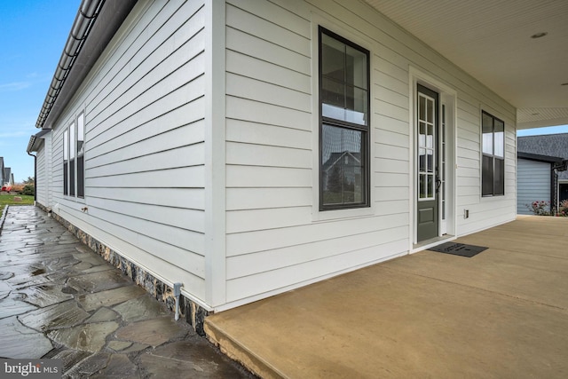 view of property exterior featuring covered porch