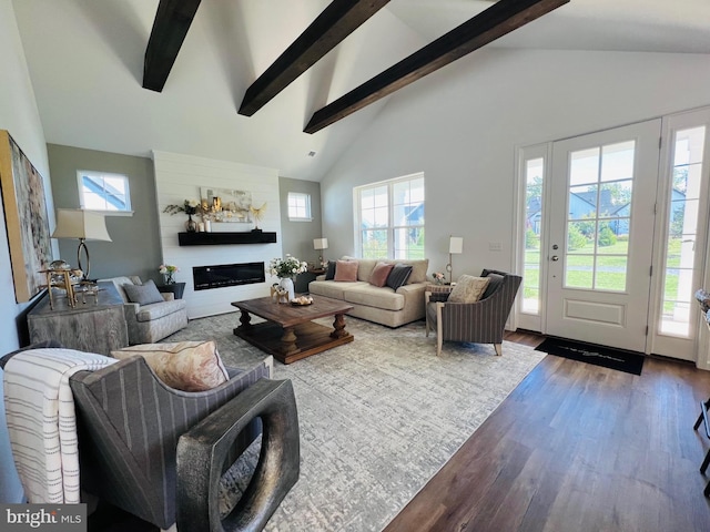 living room with beam ceiling, hardwood / wood-style floors, and high vaulted ceiling