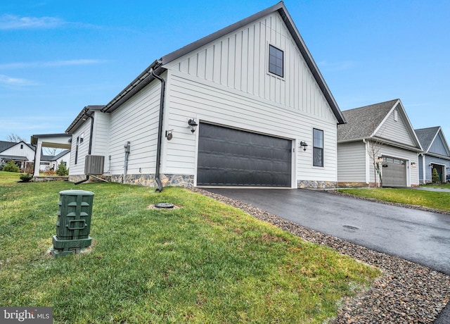 view of side of property featuring a garage and a yard