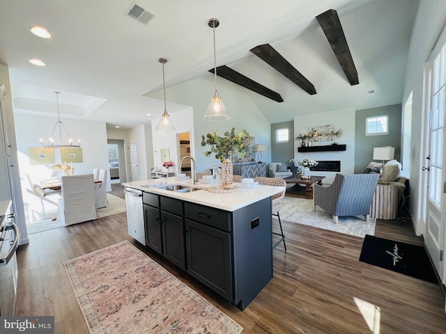 kitchen featuring dishwasher, sink, hanging light fixtures, an island with sink, and dark hardwood / wood-style flooring