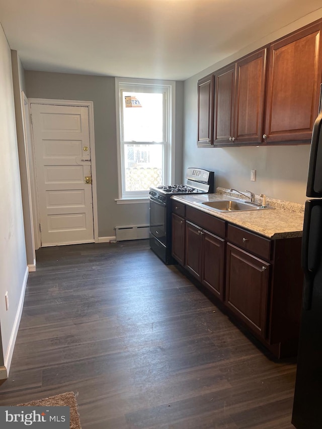 kitchen with baseboard heating, dark hardwood / wood-style flooring, black appliances, dark brown cabinets, and sink