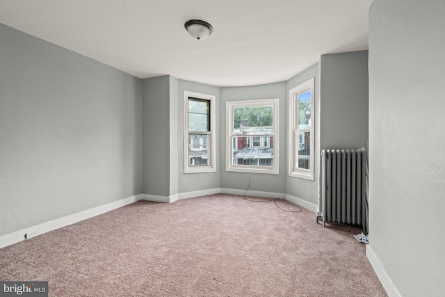 carpeted spare room with radiator