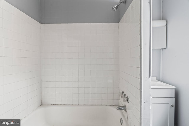 full bathroom with vanity, tiled shower / bath combo, and toilet