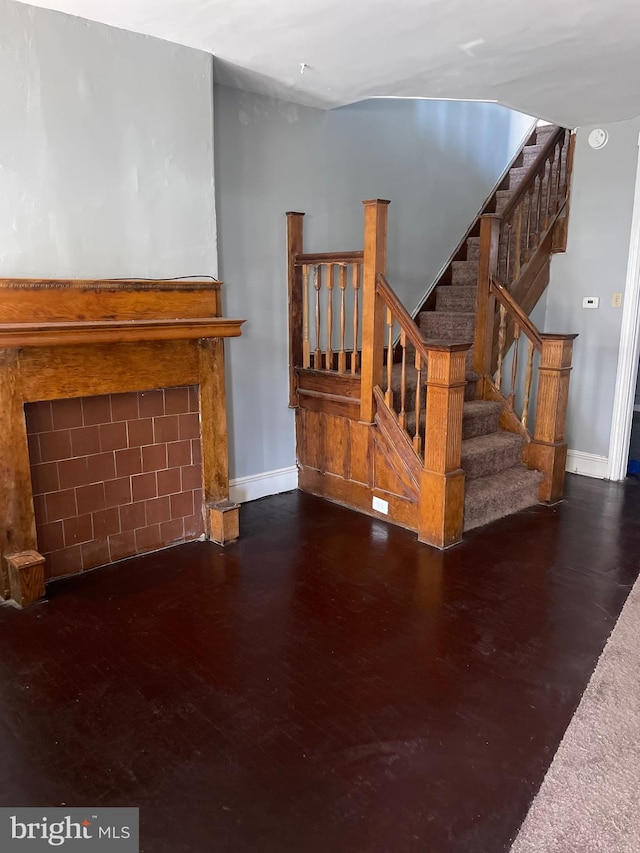 unfurnished living room with dark hardwood / wood-style floors