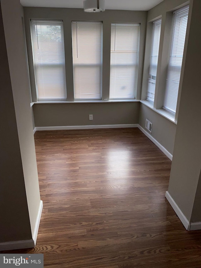 unfurnished room featuring dark wood-type flooring