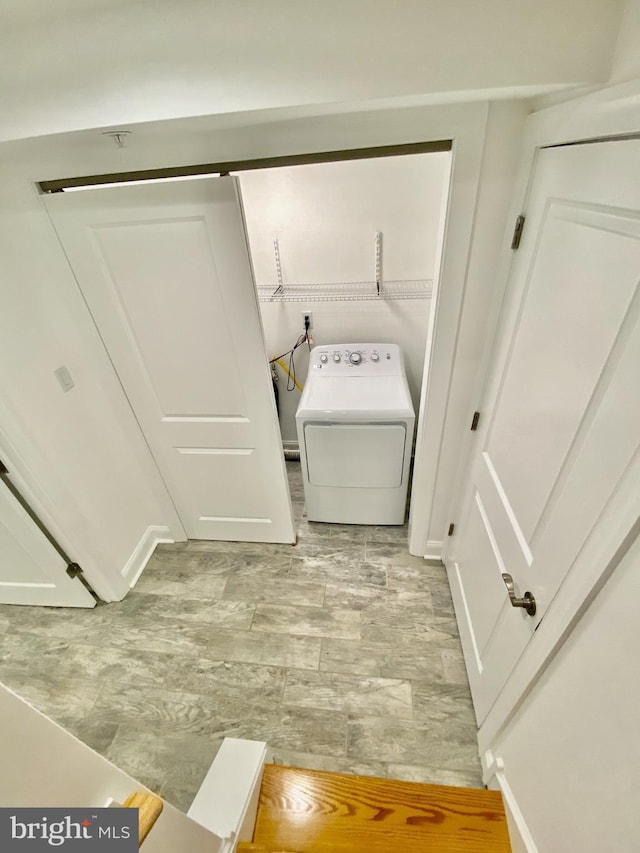 laundry area with light tile flooring and washer / clothes dryer