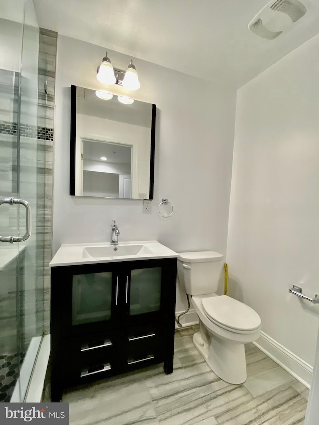 bathroom featuring walk in shower, toilet, hardwood / wood-style flooring, and vanity