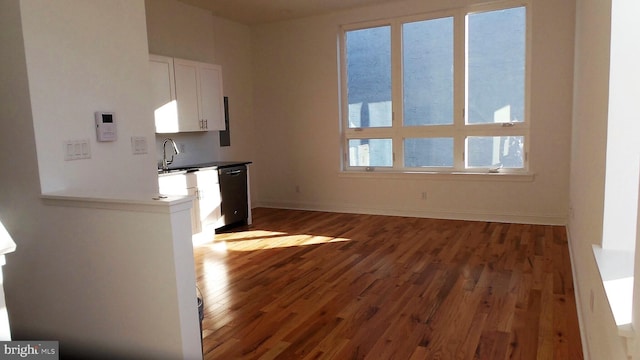 unfurnished living room with dark hardwood / wood-style floors and sink