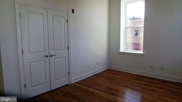 unfurnished bedroom featuring dark wood-type flooring