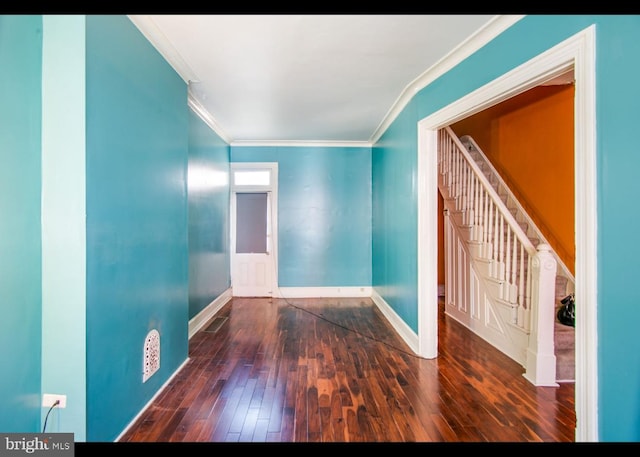 spare room featuring ornamental molding and dark hardwood / wood-style flooring